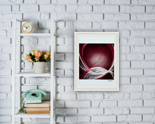 Framed abstract, red and white paper artwork on a white brick wall with a shelf and decor items. Sold from UK small business.