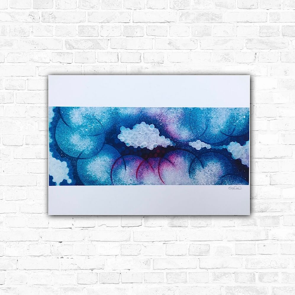 Contemporary wall art featuring cloud-like shapes in blue and pink tones on a white background, displayed against a brick wall.