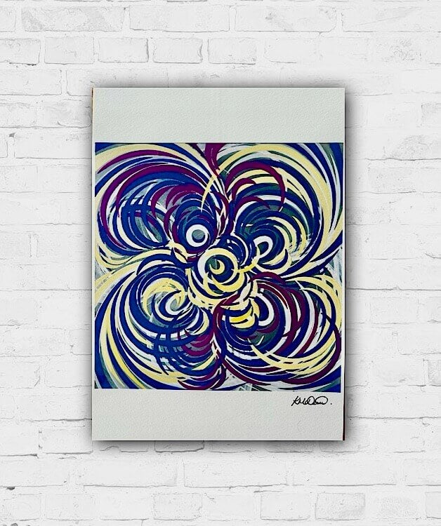 Colourful art displayed on a white wall, featuring bold swirls of blue, yellow, and purple with a signature in the lower right corner.