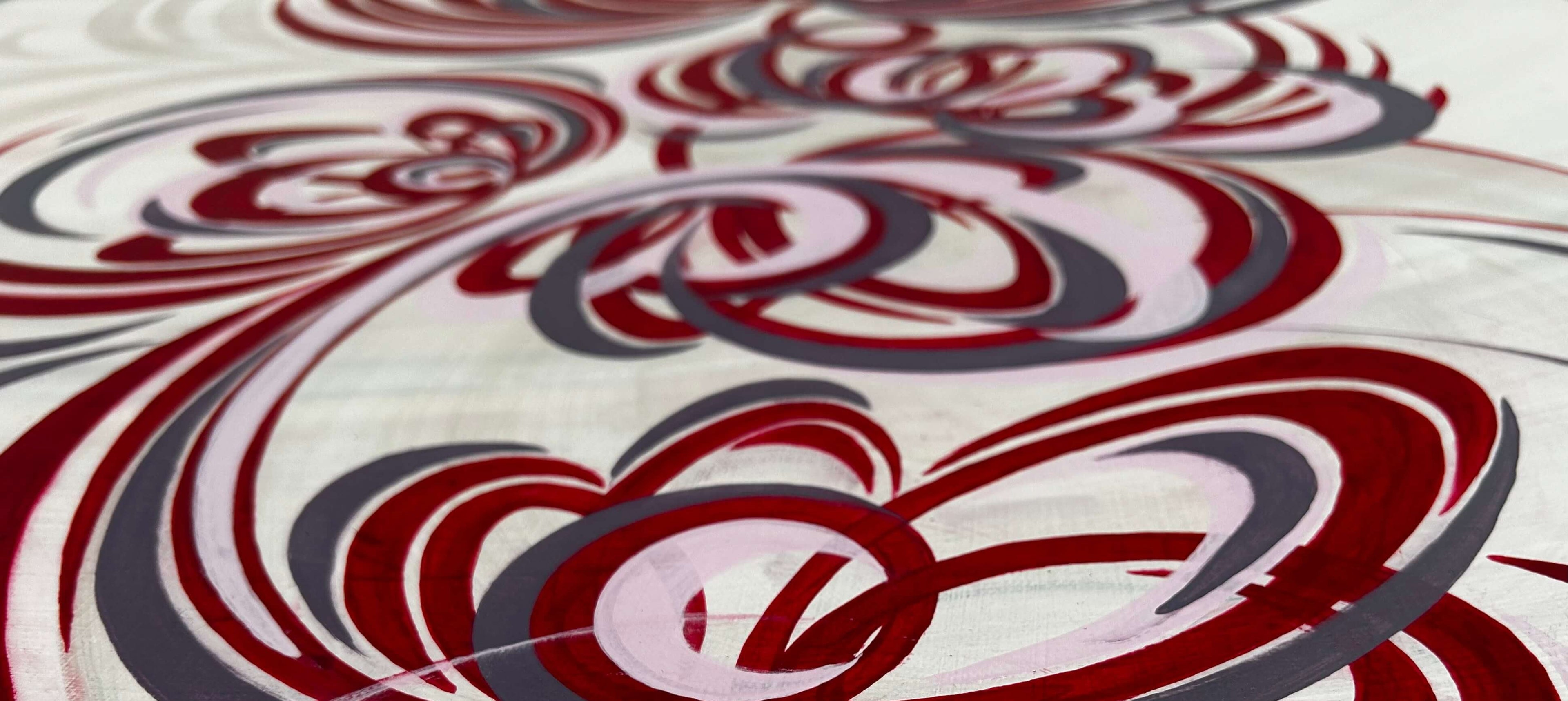 an expression of originality through  art UK. A close up of a red, pink and purple abstract flower painting.