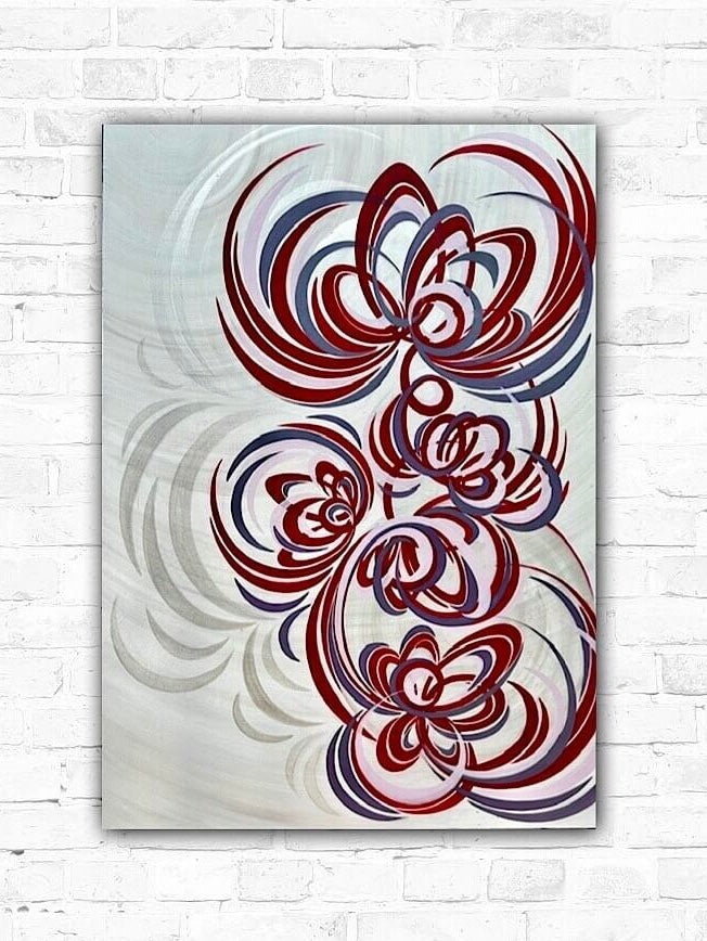 A hand-painted large wall art with red, pink, and purple colours, signed by the artist on the bottom right.
