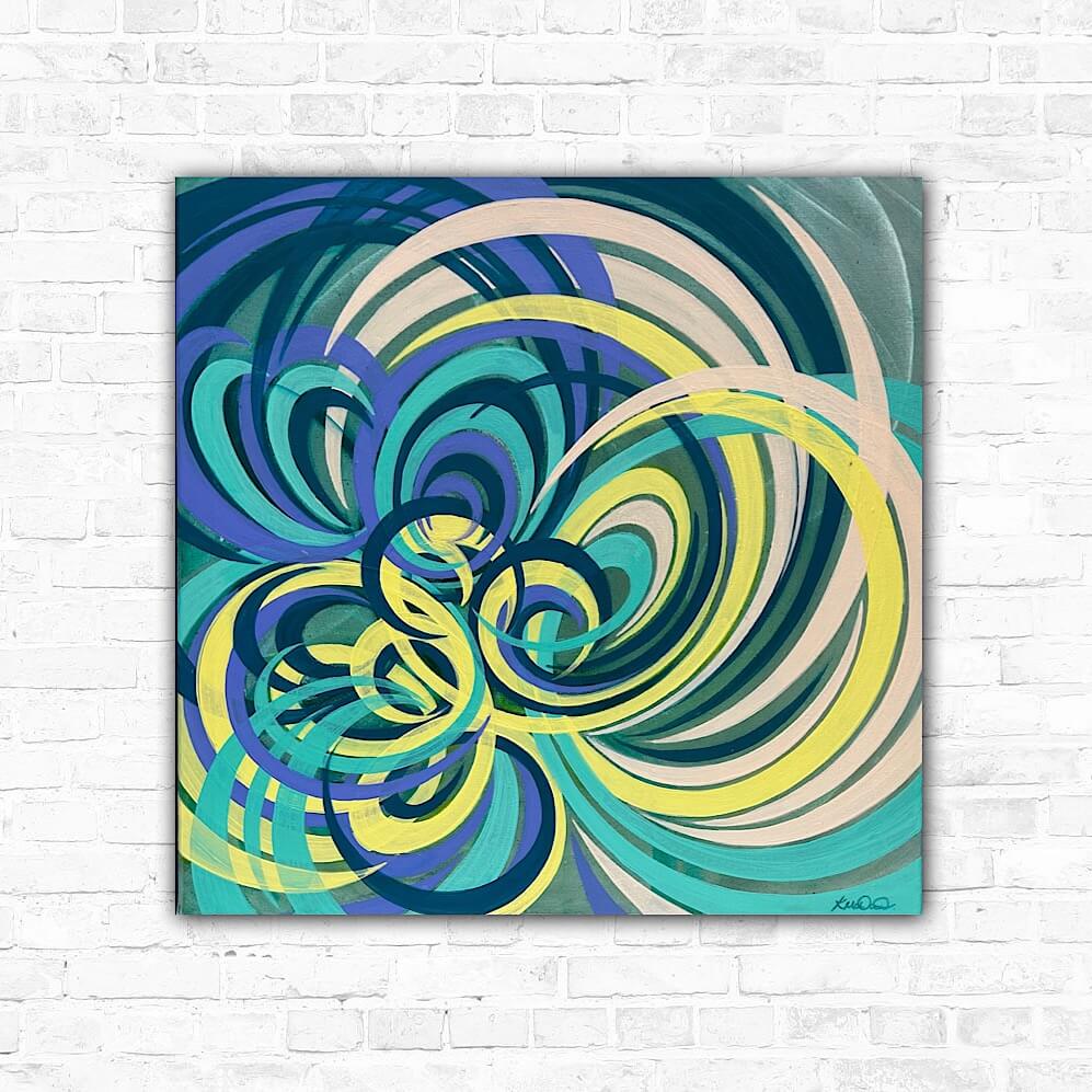 A vibrant flower painting featuring swirling patterns in multicolored acrylic paints, including yellow, purple, navy, turquoise, and peach, on a white brick wall background.