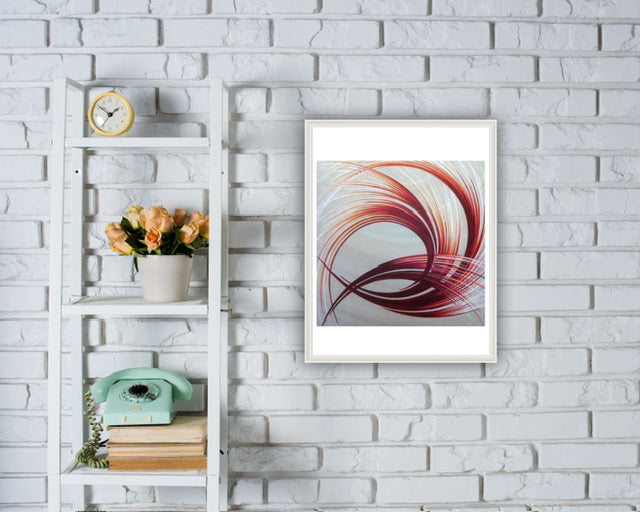 Framed colourful orange and white abstract pattern on a white brick wall with a shelf and decor items.