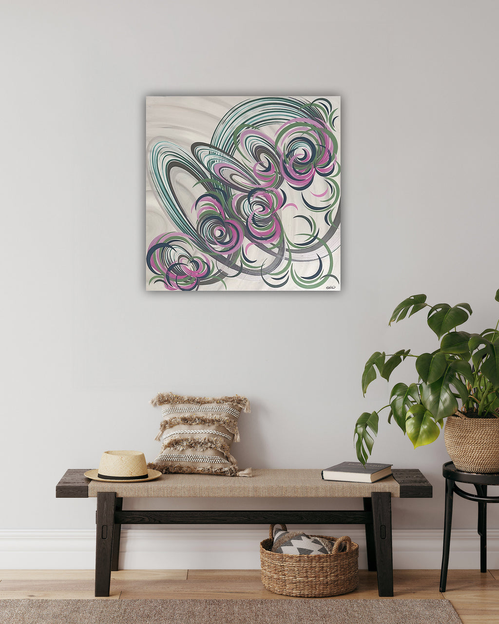 A floral abstract painting with a pink, blue, green and cream colour palette, hung on the wall in a hallway scene.