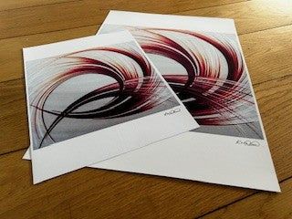 Two abstract art prints with an orange and white pattern, signed by the artist.