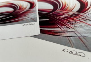 Abstract art prints with a colourful pattern in orange and white tones and a signature on a plain background