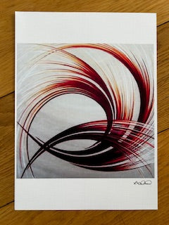 Abstract art print with a colourful pattern and swirling design on a wooden surface